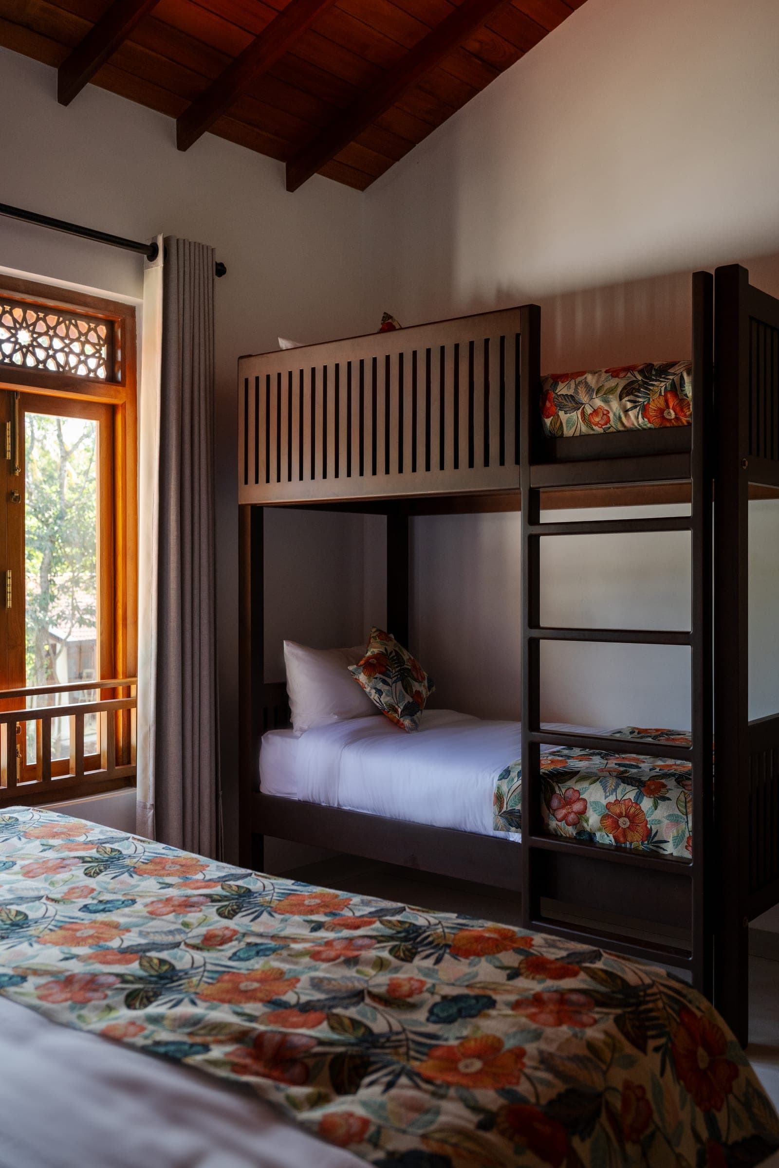The children's bunk beds in Bedroom Four, beside a window onto the garden